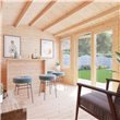 BillyOh Dorset Log Cabin interior with chair, stools, and hanging pictures